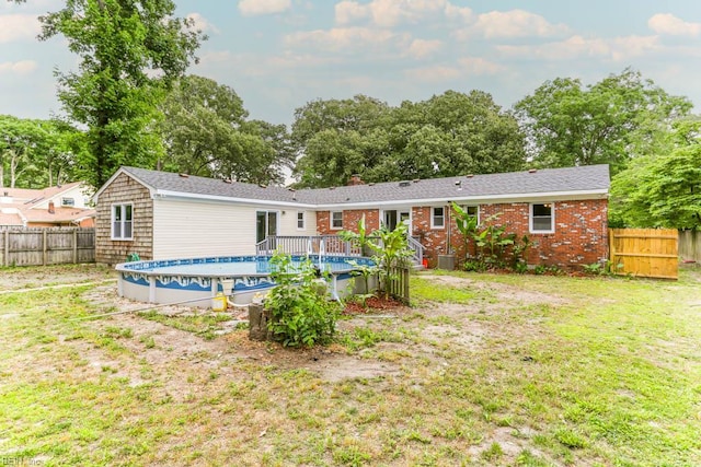 rear view of house with brick siding and central AC unit