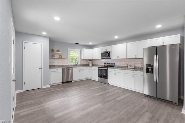 3105 Hillburn Dr, Chesapeake, VA 23323 - kitchen with appliances with stainless steel finishes, open shelves, white cabinetry, a sink, and light wood-type flooring