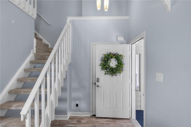 entrance foyer with wood finished floors and stairs