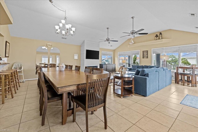 609 S Atlantic Ave, Virginia Beach, VA 23451 - dining area with lofted ceiling, light tile patterned floors, ceiling fan, arched walkways, and a chandelier