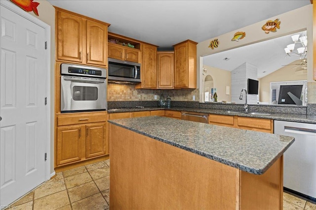 609 S Atlantic Ave, Virginia Beach, VA 23451 - kitchen with appliances with stainless steel finishes, a sink, tasteful backsplash, and dark stone counters