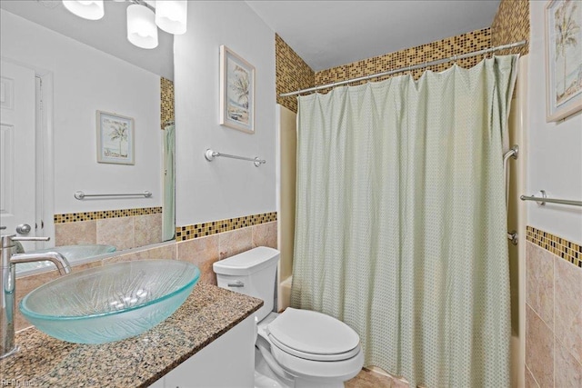 609 S Atlantic Ave, Virginia Beach, VA 23451 - bathroom with tile walls, vanity, shower / bath combination with curtain, toilet, and wainscoting