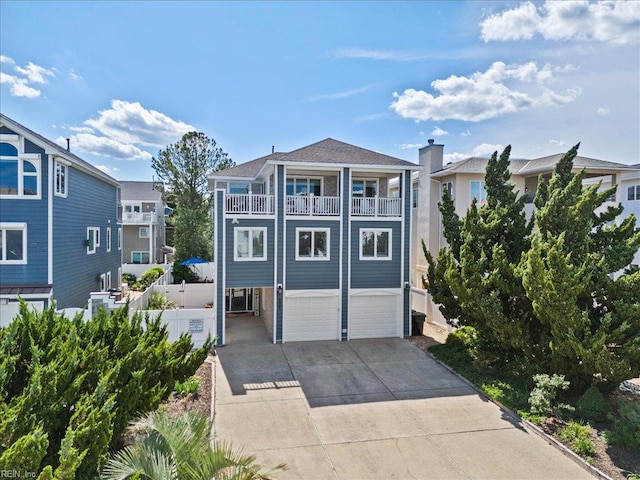 609 S Atlantic Ave, Virginia Beach, VA 23451 - view of front facade featuring a balcony, a garage, and driveway