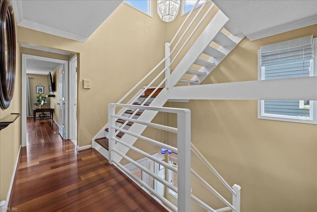 609 S Atlantic Ave, Virginia Beach, VA 23451 - stairway with crown molding, wood finished floors, a textured ceiling, and baseboards