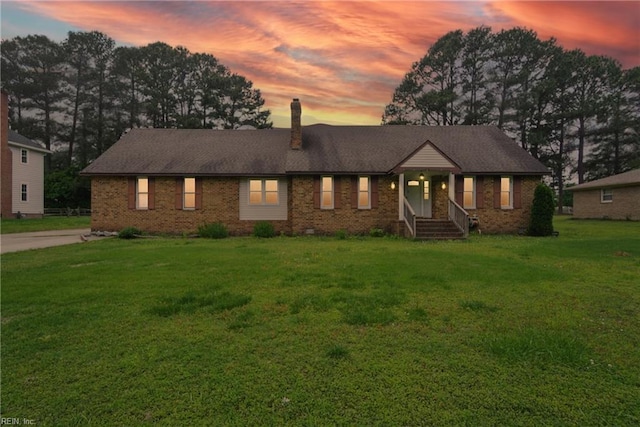1237 Peachtree Dr, Suffolk, VA 23434 - ranch-style house with a chimney, brick siding, and a front lawn