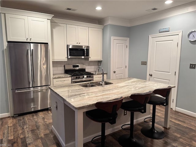 5305 Sports Club Run Unit 403, Suffolk, VA 23435 - kitchen featuring stainless steel appliances, a sink, dark wood-style floors, ornamental molding, and decorative backsplash