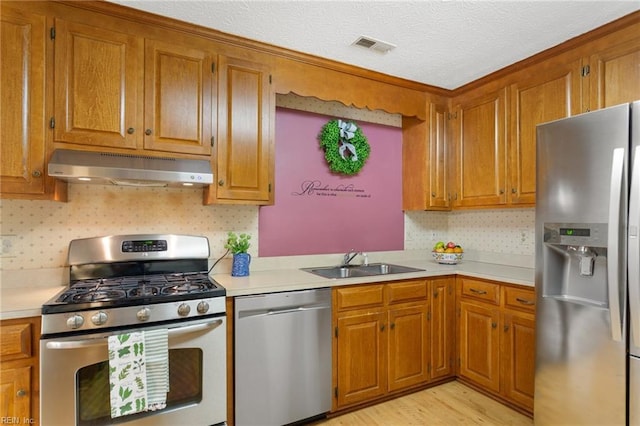 12 Critzos Ct, Hampton, VA 23669 - kitchen featuring appliances with stainless steel finishes, under cabinet range hood, a sink, light countertops, and a textured ceiling