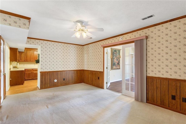 12 Critzos Ct, Hampton, VA 23669 - empty room featuring a wainscoted wall, wooden walls, a ceiling fan, light carpet, and crown molding