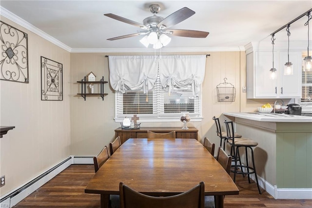 dining room featuring a baseboard radiator, dark wood finished floors, ceiling fan, ornamental molding, and baseboards