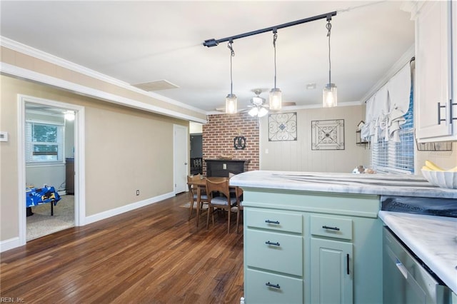 kitchen featuring ceiling fan, light countertops, dark wood finished floors, a fireplace, and baseboards