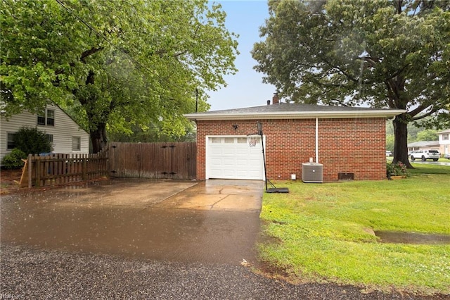 garage with central AC unit and driveway