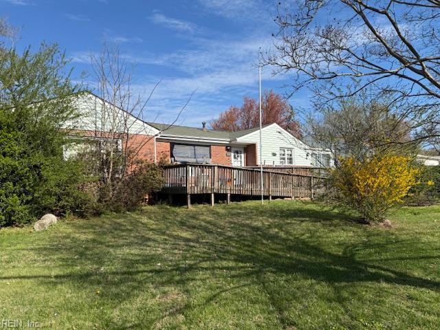 609 Aragona Blvd, Virginia Beach, VA 23462 - back of house featuring a wooden deck, a lawn, and brick siding