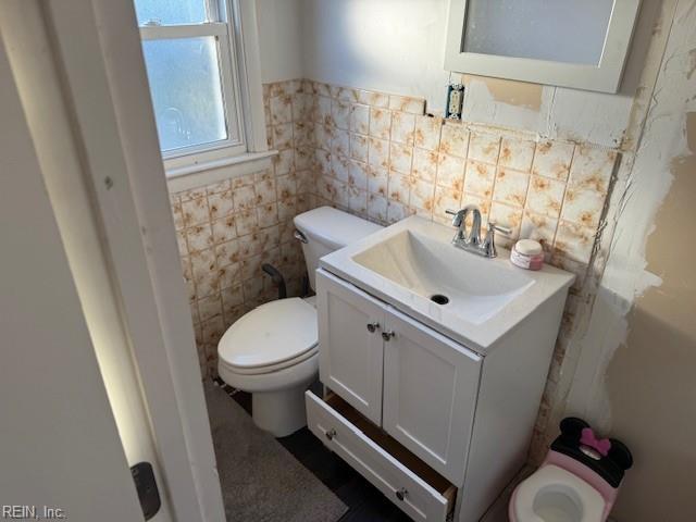 609 Aragona Blvd, Virginia Beach, VA 23462 - bathroom featuring toilet, tile walls, vanity, and wainscoting