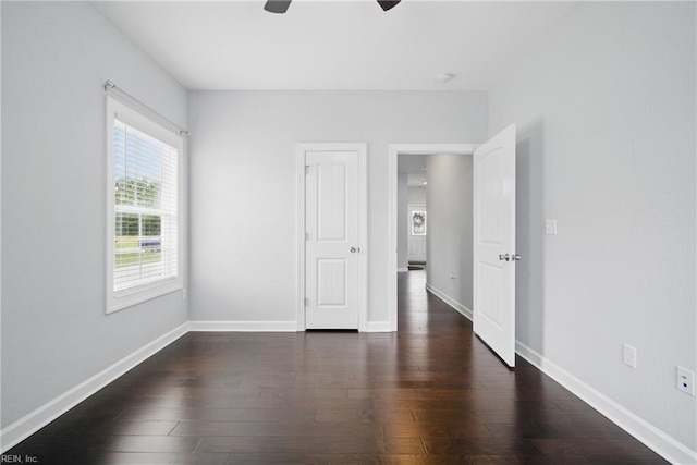 4030 Evan Cir, Suffolk, VA 23435 - unfurnished bedroom featuring dark wood-style floors, baseboards, and ceiling fan