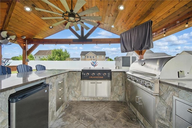 4030 Evan Cir, Suffolk, VA 23435 - view of patio with fence, grilling area, ceiling fan, and an outdoor kitchen