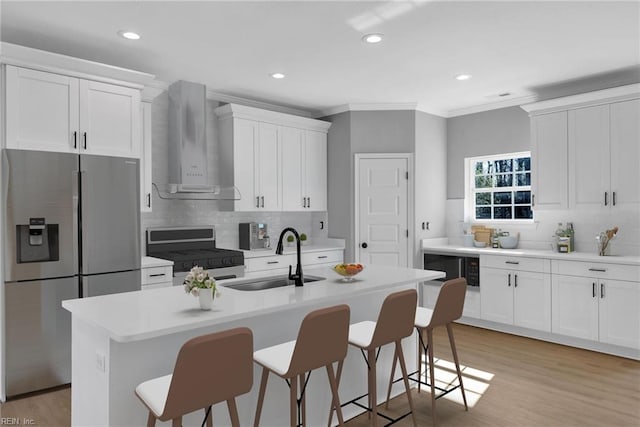 4780 Seal Ln, Virginia Beach, VA 23450 - kitchen with stainless steel appliances, wall chimney range hood, a sink, a breakfast bar area, and crown molding