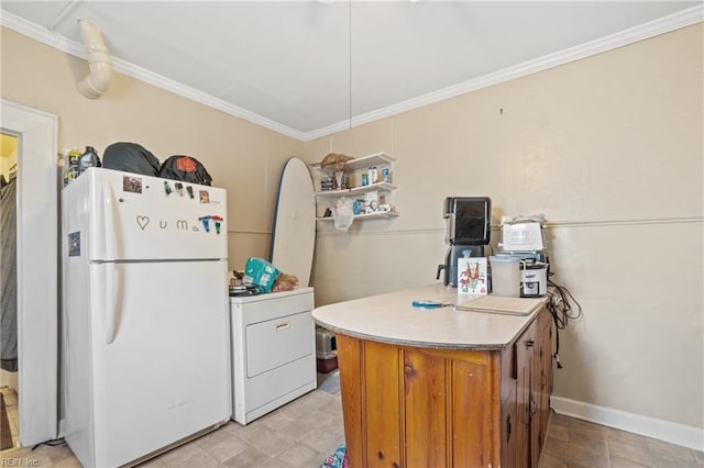 344 Maryland Ave, Portsmouth, VA 23707 - kitchen featuring freestanding refrigerator, crown molding, brown cabinets, light countertops, and washer / dryer