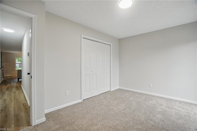 1600 Walsh Ct, Virginia Beach, VA 23454 - unfurnished bedroom featuring a textured ceiling, baseboards, a closet, and carpet