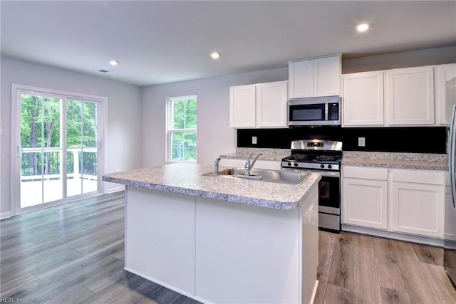 307 Lorraine Dr, Williamsburg, VA 23185 - kitchen with appliances with stainless steel finishes, a sink, white cabinetry, light wood-type flooring, and recessed lighting