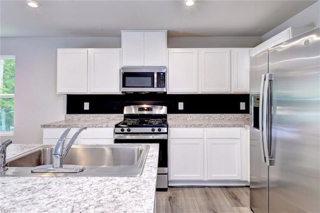 307 Lorraine Dr, Williamsburg, VA 23185 - kitchen with stainless steel appliances, a sink, white cabinetry, light countertops, and recessed lighting