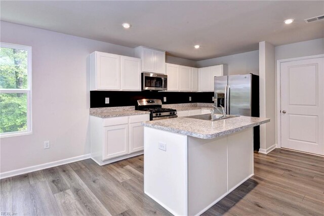 307 Lorraine Dr, Williamsburg, VA 23185 - kitchen with appliances with stainless steel finishes, a sink, light countertops, white cabinetry, and light wood finished floors