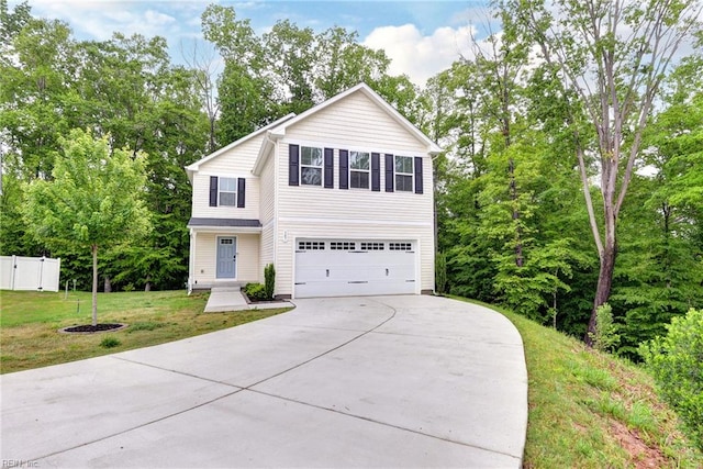 307 Lorraine Dr, Williamsburg, VA 23185 - traditional-style house with concrete driveway, a garage, and view of scattered trees