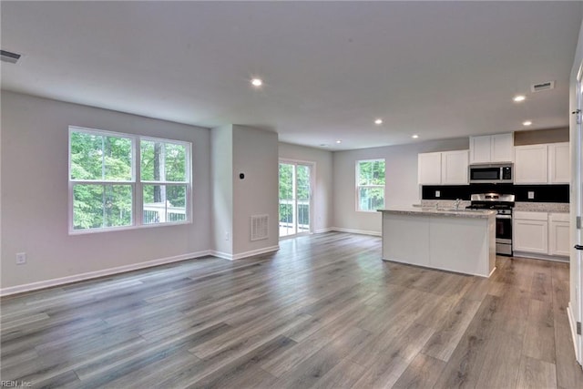 307 Lorraine Dr, Williamsburg, VA 23185 - kitchen with appliances with stainless steel finishes, open floor plan, recessed lighting, light wood-type flooring, and white cabinets