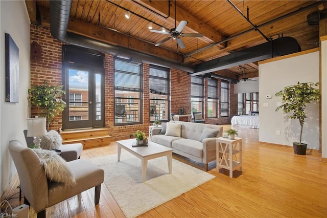 230 W Tazewell St Unit 303, Norfolk, VA 23510 - living room featuring brick wall, wooden ceiling, wood finished floors, a ceiling fan, and beam ceiling