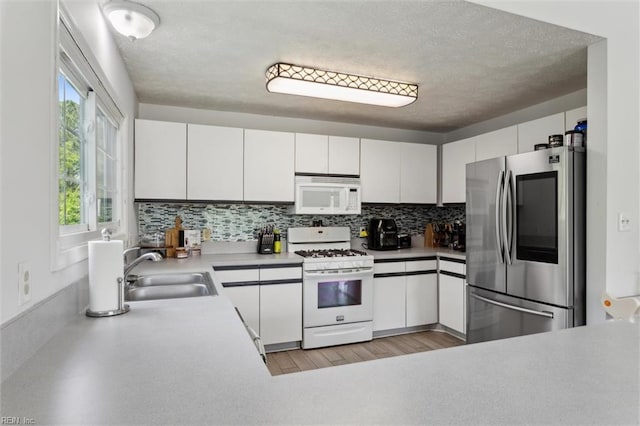 13 Dandy Point Rd, Hampton, VA 23664 - kitchen featuring white appliances, a sink, tasteful backsplash, light countertops, and white cabinets