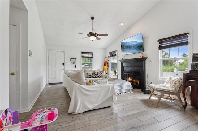 13 Dandy Point Rd, Hampton, VA 23664 - living area with ceiling fan, a lit fireplace, wood finished floors, a textured ceiling, and high vaulted ceiling