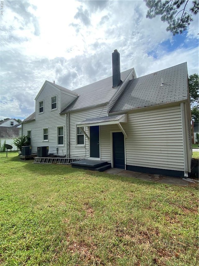 3814 Lenoir Cir, Norfolk, VA 23513 - back of house featuring a yard, a chimney, and cooling unit