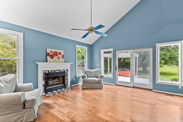 253 S George Washington Hwy, Chesapeake, VA 23323 - living area featuring wood finished floors, a tiled fireplace, healthy amount of natural light, high vaulted ceiling, and a ceiling fan