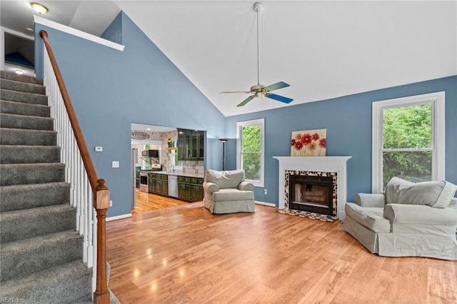253 S George Washington Hwy, Chesapeake, VA 23323 - living room with light wood finished floors, stairs, high vaulted ceiling, plenty of natural light, and a ceiling fan