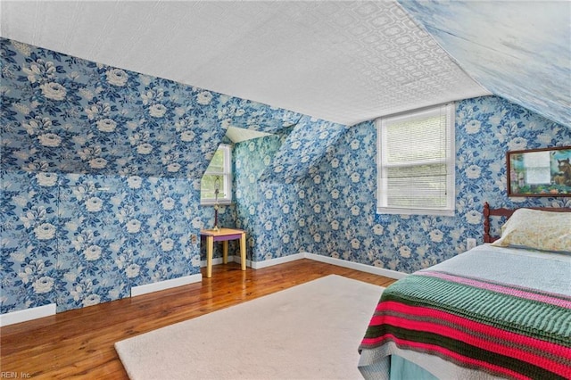 253 S George Washington Hwy, Chesapeake, VA 23323 - bedroom featuring wood finished floors, multiple windows, lofted ceiling, baseboards, and wallpapered walls