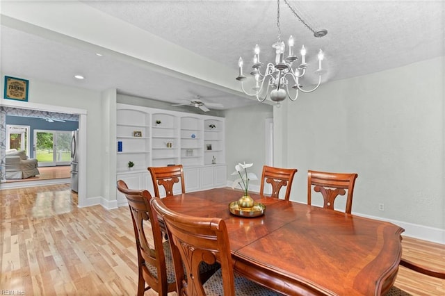 253 S George Washington Hwy, Chesapeake, VA 23323 - dining room with baseboards, light wood-style flooring, a textured ceiling, a chandelier, and a ceiling fan