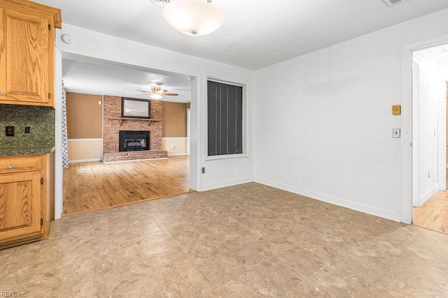 27195 Dogwood Bend Rd, Franklin, VA 23851 - unfurnished living room with a ceiling fan, a fireplace, baseboards, and light flooring