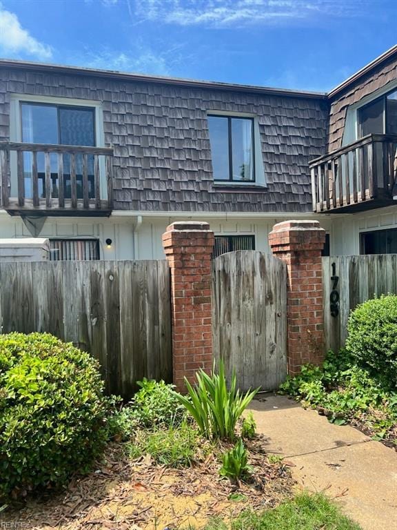 1705 Ocean Bay Dr, Virginia Beach, VA 23454 - view of front facade featuring mansard roof and a balcony