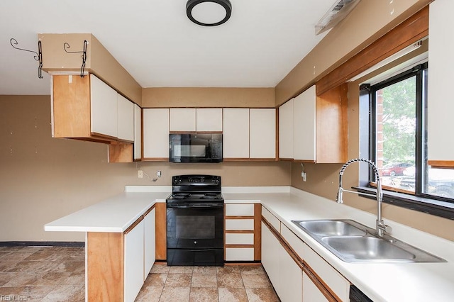 1705 Ocean Bay Dr, Virginia Beach, VA 23454 - kitchen featuring black appliances, a sink, white cabinetry, and light countertops