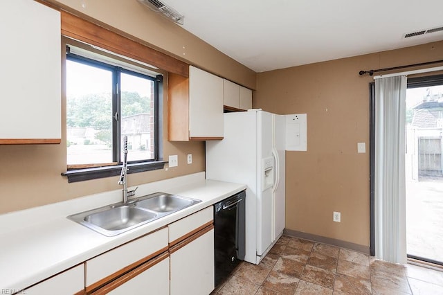 1705 Ocean Bay Dr, Virginia Beach, VA 23454 - kitchen featuring black dishwasher, a sink, white cabinetry, light countertops, and light stone finish floors