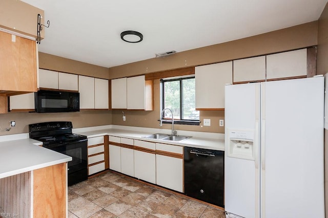 1705 Ocean Bay Dr, Virginia Beach, VA 23454 - kitchen with black appliances, a sink, white cabinetry, and light countertops