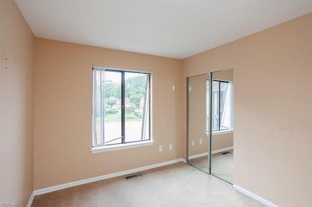 1705 Ocean Bay Dr, Virginia Beach, VA 23454 - unfurnished bedroom with a closet, baseboards, and light carpet
