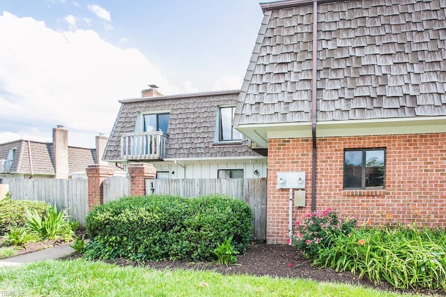 1705 Ocean Bay Dr, Virginia Beach, VA 23454 - view of property exterior featuring brick siding, mansard roof, and a chimney