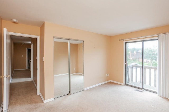1705 Ocean Bay Dr, Virginia Beach, VA 23454 - unfurnished bedroom with access to exterior, light carpet, a closet, and baseboards
