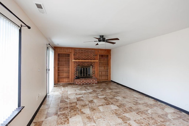 1705 Ocean Bay Dr, Virginia Beach, VA 23454 - unfurnished living room featuring built in features, baseboards, ceiling fan, light stone finish floors, and a fireplace