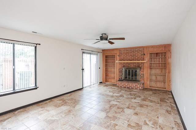 1705 Ocean Bay Dr, Virginia Beach, VA 23454 - unfurnished living room with built in shelves, baseboards, ceiling fan, and a fireplace