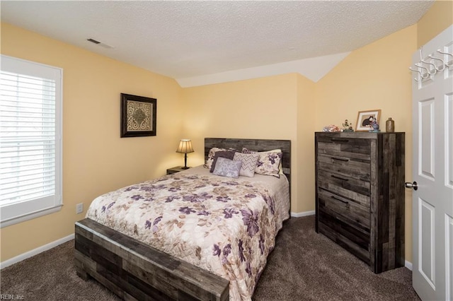 carpeted bedroom featuring lofted ceiling, baseboards, and a textured ceiling