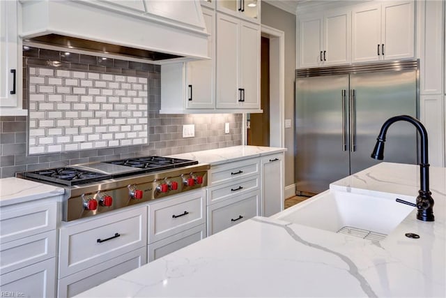 116 Formby, Williamsburg, VA 23188 - kitchen with stainless steel appliances, custom exhaust hood, white cabinets, a sink, and ornamental molding