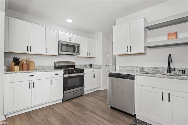 332 Shawen Dr, Hampton, VA 23669 - kitchen featuring appliances with stainless steel finishes, open shelves, a sink, white cabinets, and wood finished floors