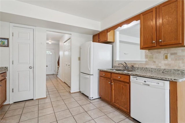 6017 Glen View Dr, Virginia Beach, VA 23464 - kitchen with white appliances, a sink, brown cabinets, light tile patterned floors, and tasteful backsplash
