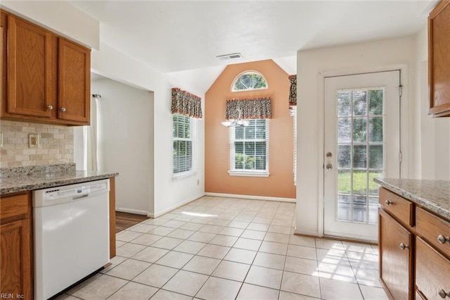6017 Glen View Dr, Virginia Beach, VA 23464 - kitchen with white dishwasher, brown cabinets, backsplash, vaulted ceiling, and light tile patterned floors